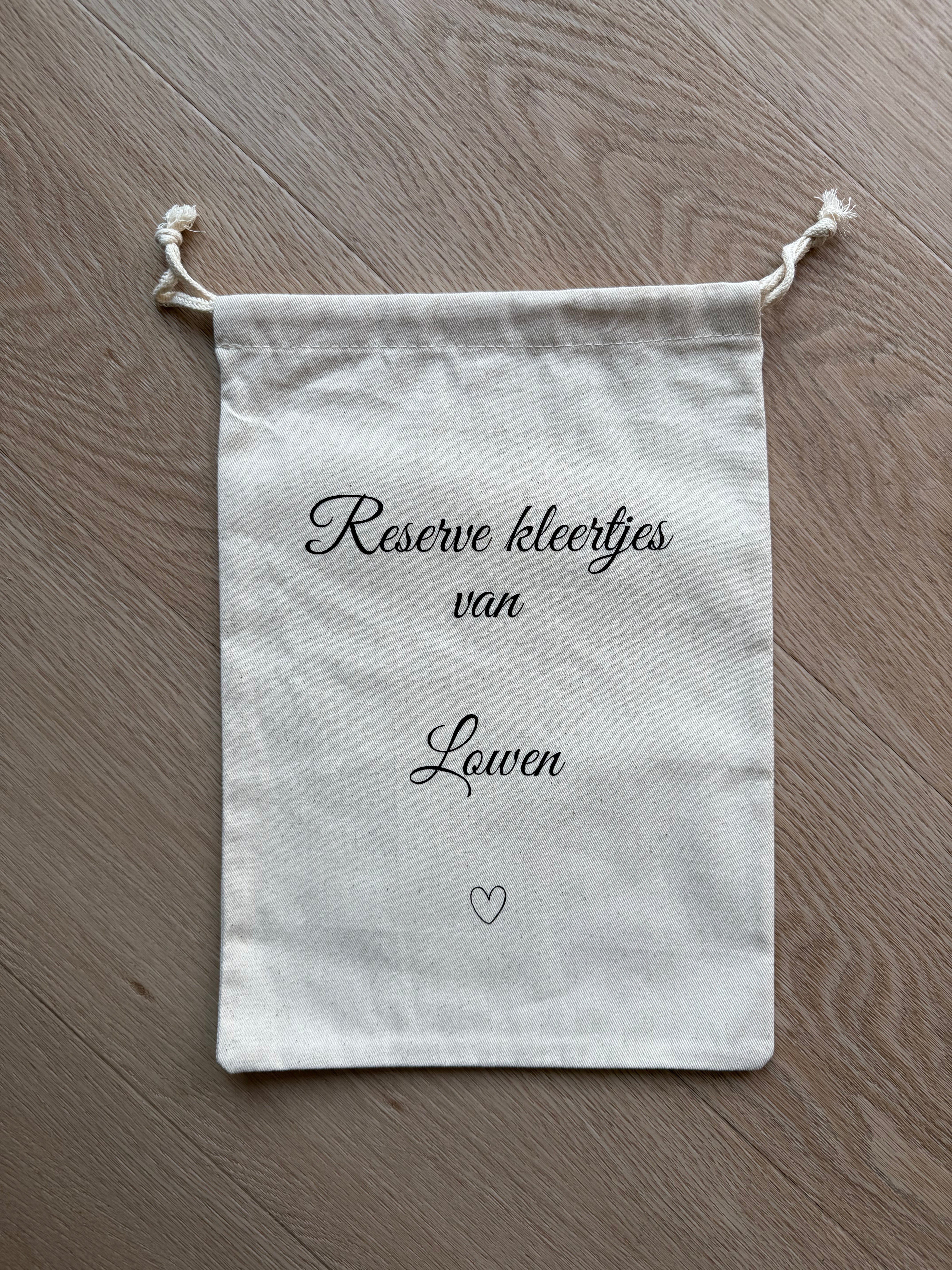 Bewaarzakje reserve kleertjes met naam
